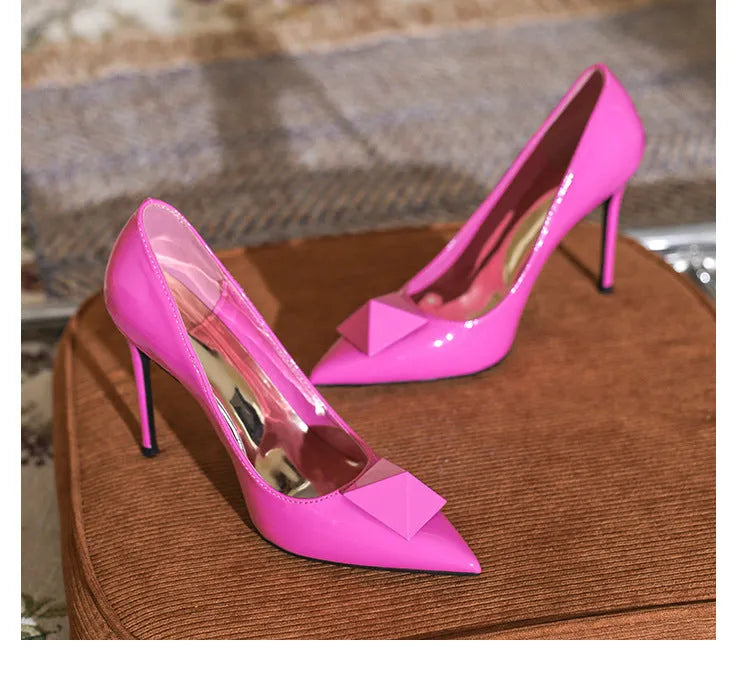 Pink patent leather women's pointed toe stiletto heels with buckle detailing