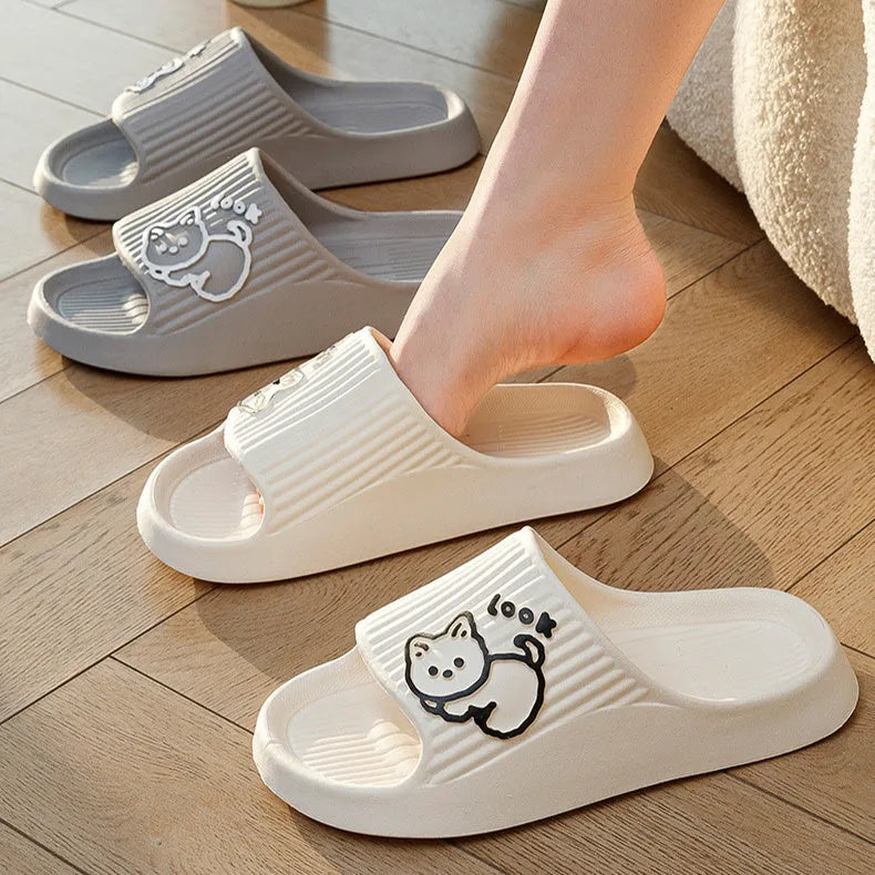 Green EVA platform flip flop slippers with a raised cat design on the upper.
