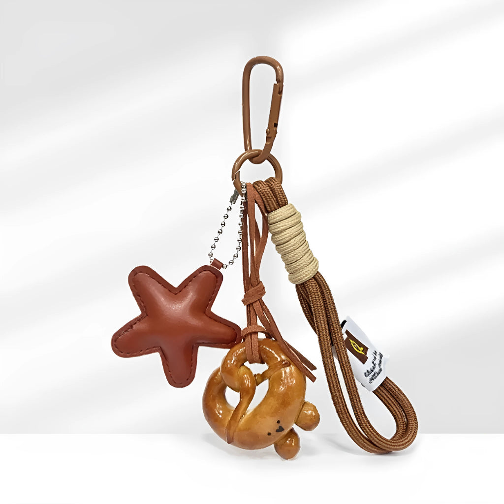 Handbag pendant charm with handmade soda bread design patterns including brown star, croissant, and bagel