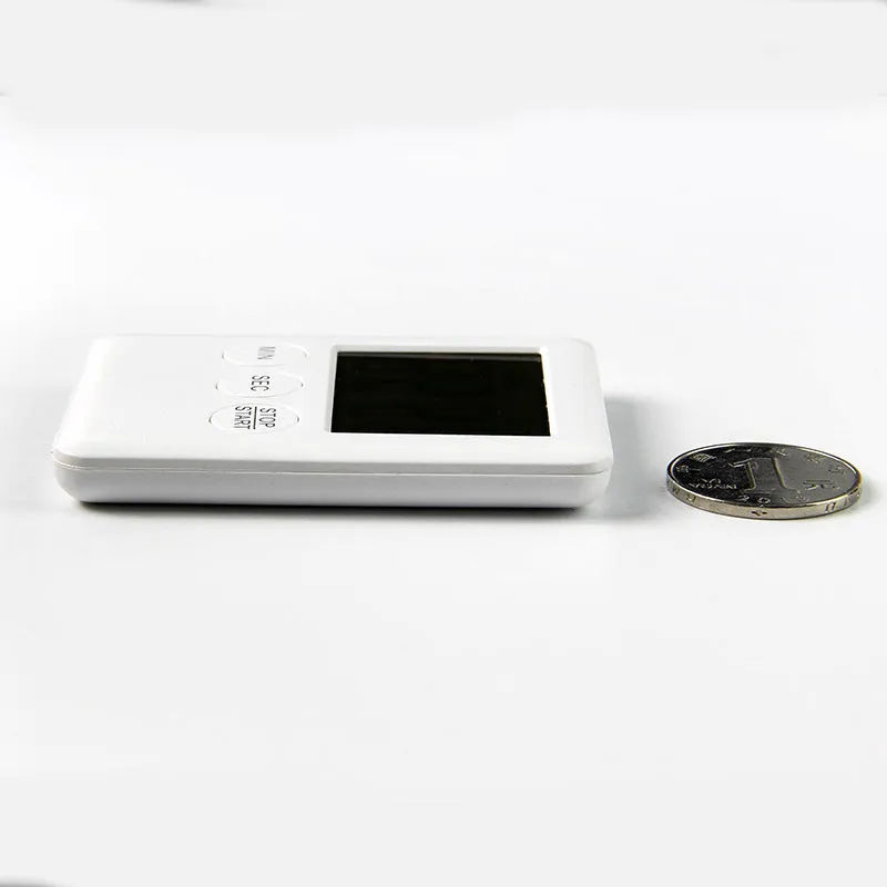 Digital kitchen timer with magnetic back showing LCD countdown display on refrigerator