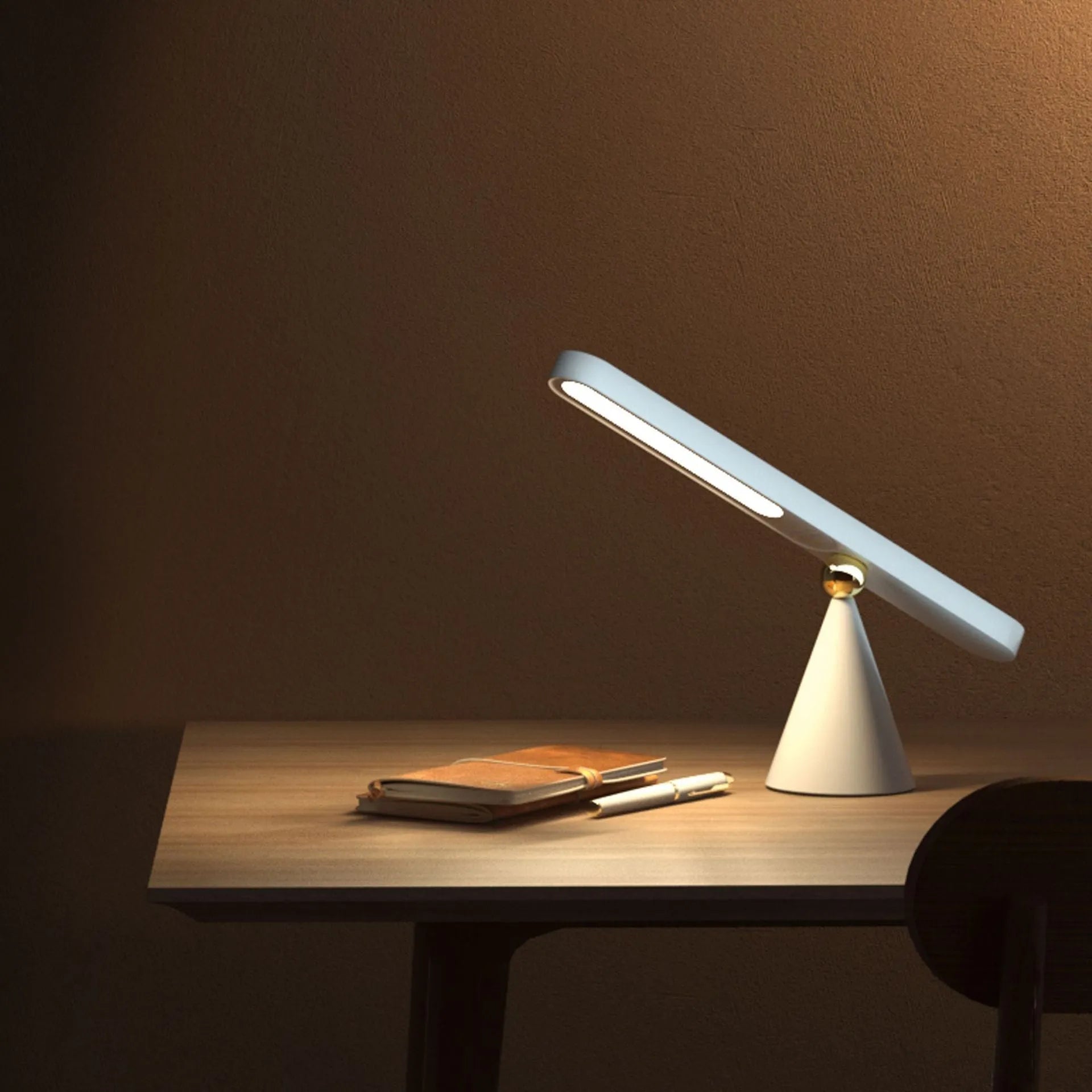 White geometric USB desk lamp with magnetic base shown on a wooden desk.