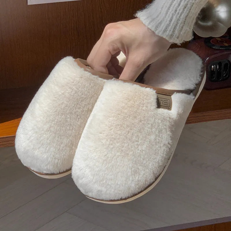 Solid colour PVC winter plush house slippers with car stitching detail on a non-slip sole.