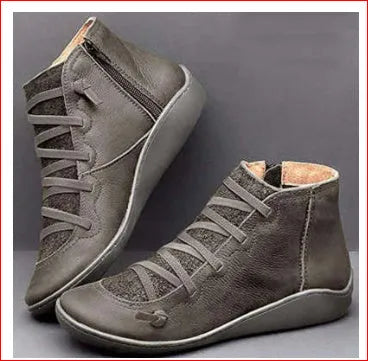 Women's black casual ankle booties with a flat wedge heel and round toe, made from PU with a rubber sole.