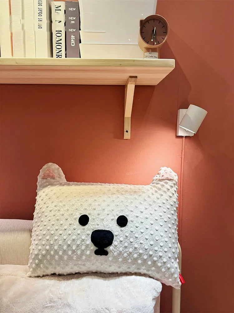 Grey or white West Highland puppy shaped pillow on a sofa, 50cm long.