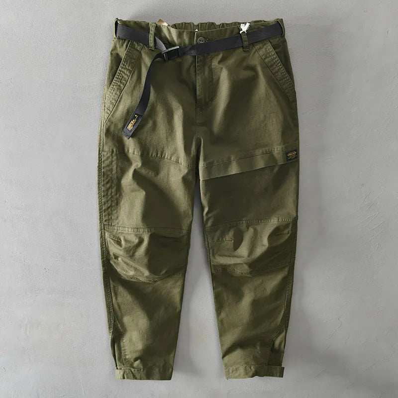 Men's khaki coloured loose-fit casual overalls with an elastic waistband on a hanger.