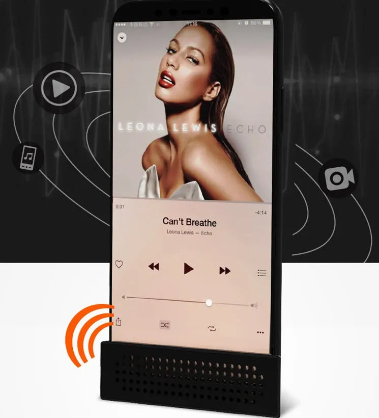 Mini portable phone amplifier bracket for Apple iPhone on a desktop in pink colour.