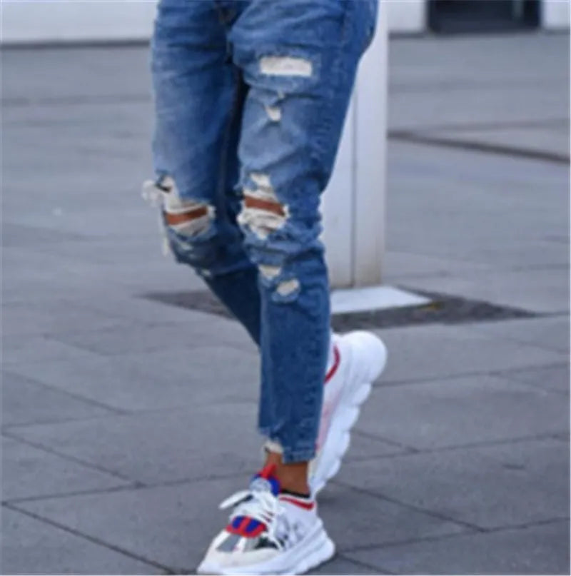 Men's deep blue cotton jeans laid flat, showing classic denim texture and five-pocket design.