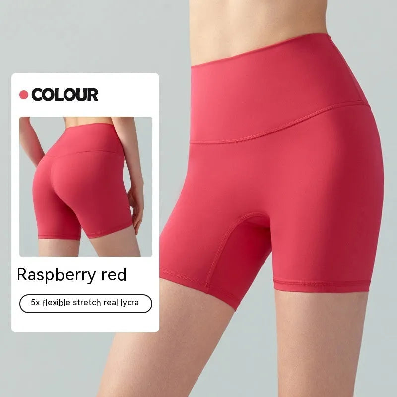 Women's high waist Lycra yoga shorts in leaf green, shown in a yoga pose.