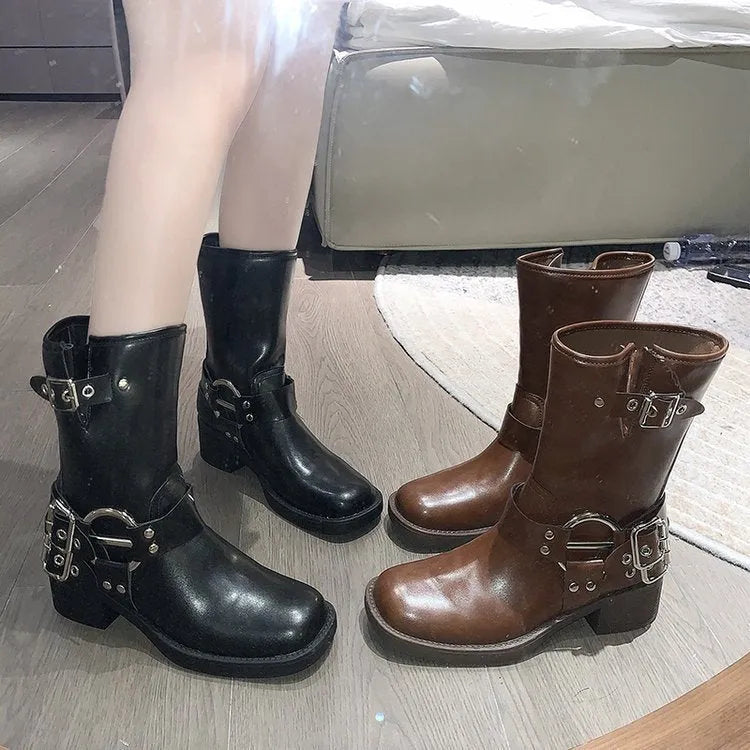 Women's black platform boots with a silver buckle detail at mid-calf height.