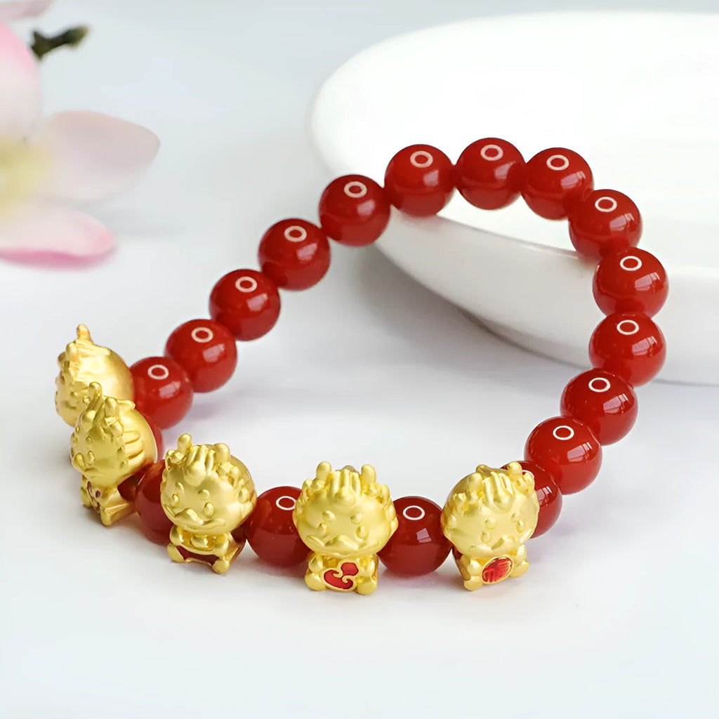 Close-up of 8mm red agate bracelet with carved Five Blessings Dragon design on wrist.