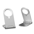 Silver vertical adjustable magnetic phone bracket for iPhone 12 series on a desk.