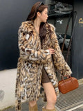 Faux fur coat with fur collar in long or mid-length style showing pocket details