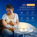 White bedside night light with touch controls, motion sensor, and rechargeable battery for nursery use.