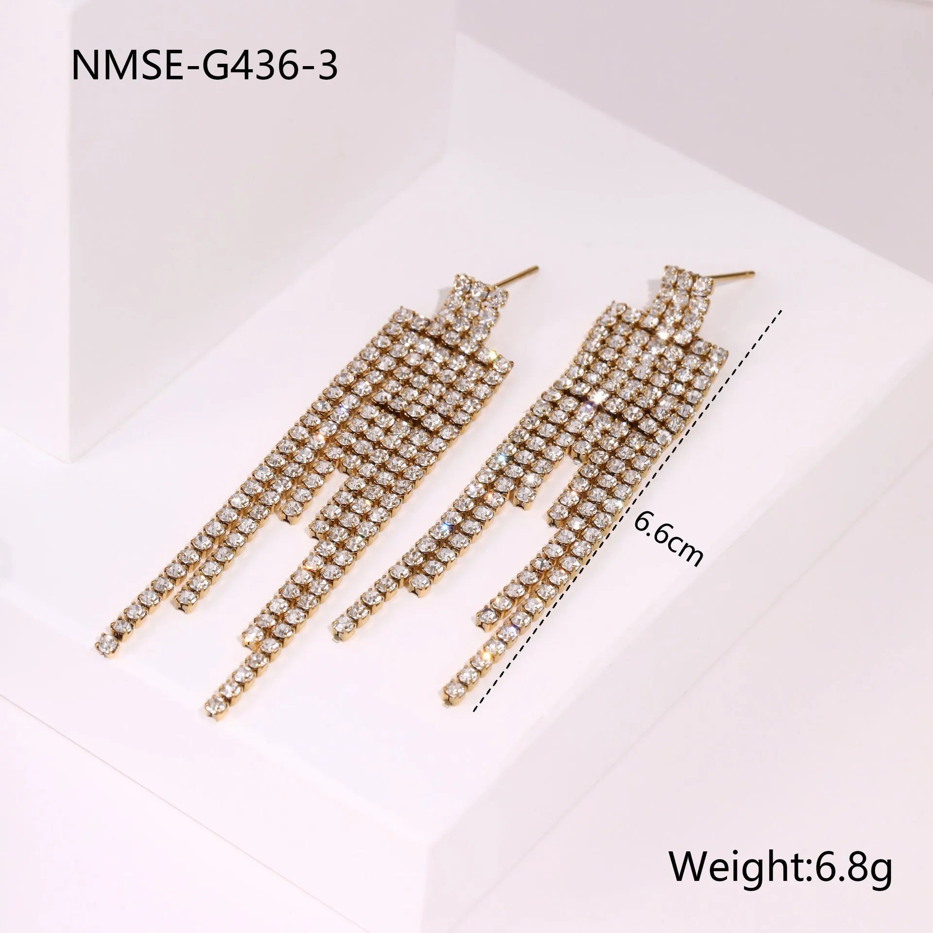 Gold electroplated stainless steel fashion earrings with heart, star, and geometric tassel design.