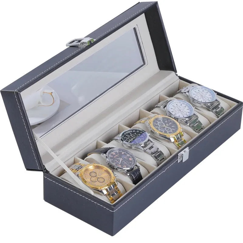 Grey leather watch storage box with clear lid showing watch compartments
