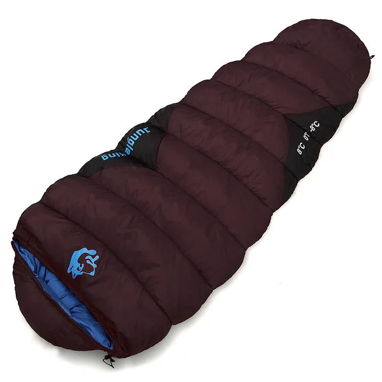 Outdoor cotton sleeping bag in Army Green with its compression storage sack laid beside it.
