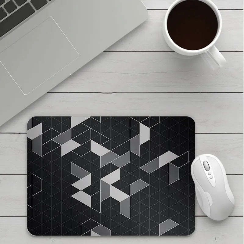 Custom cartoon thickening mouse pad on a desk, showing a colourful design with black stitched edge.