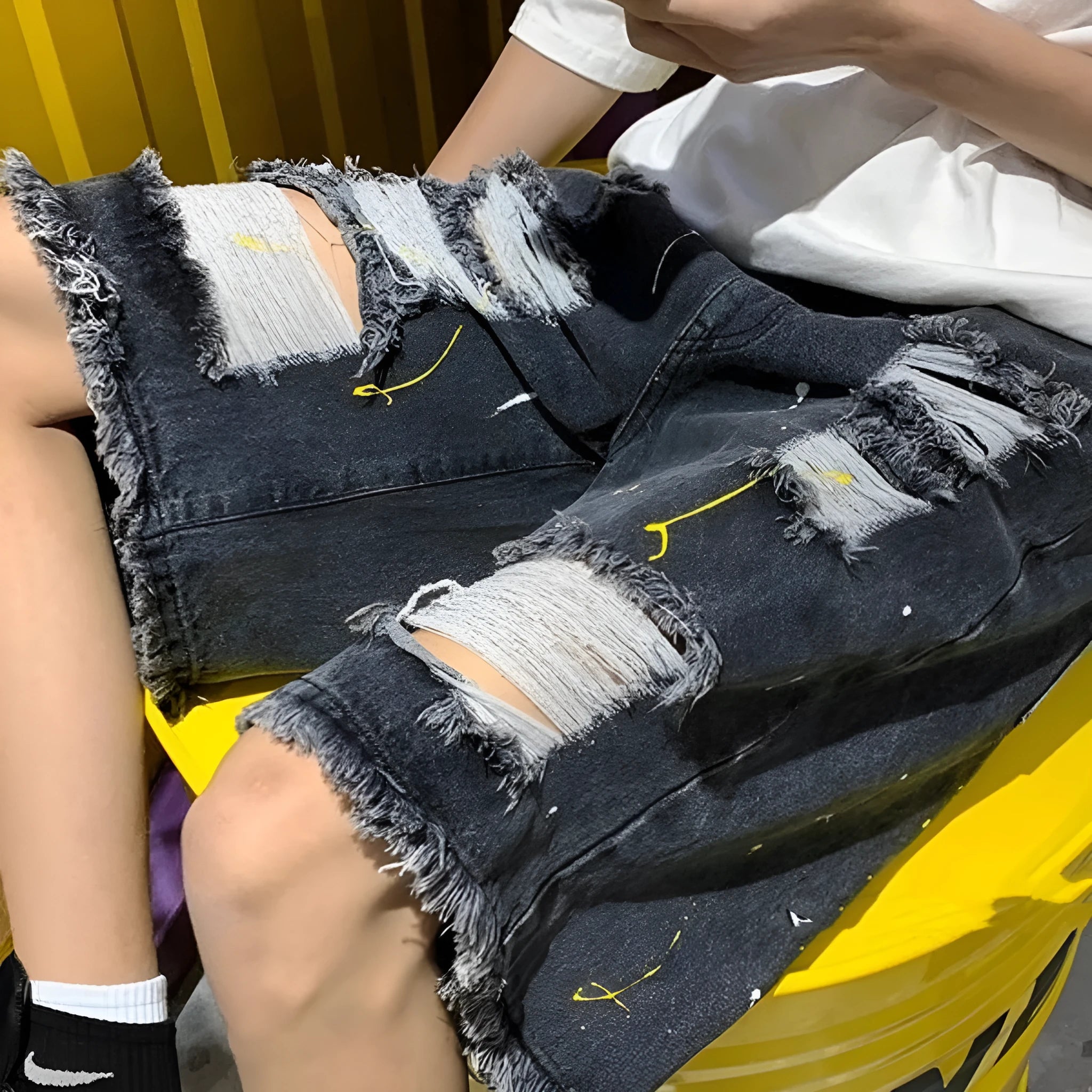 Men's water washed hole denim shorts in loose fit street style, available in black and light blue
