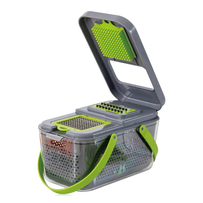 Grey multifunctional vegetable cutter with stainless steel blades, foldable compartments, and a large container on a kitchen counter