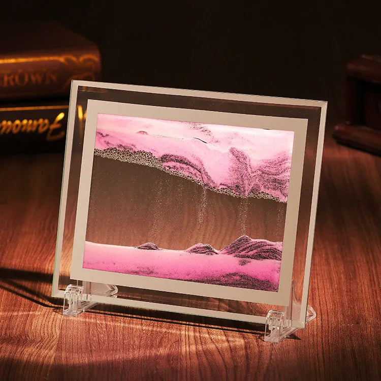 Glass quicksand painting ornament with geometric shape showing landscape sand art in black and white green colours.