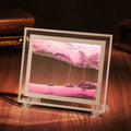 Glass quicksand painting ornament with geometric shape showing landscape sand art in black and white green colours.