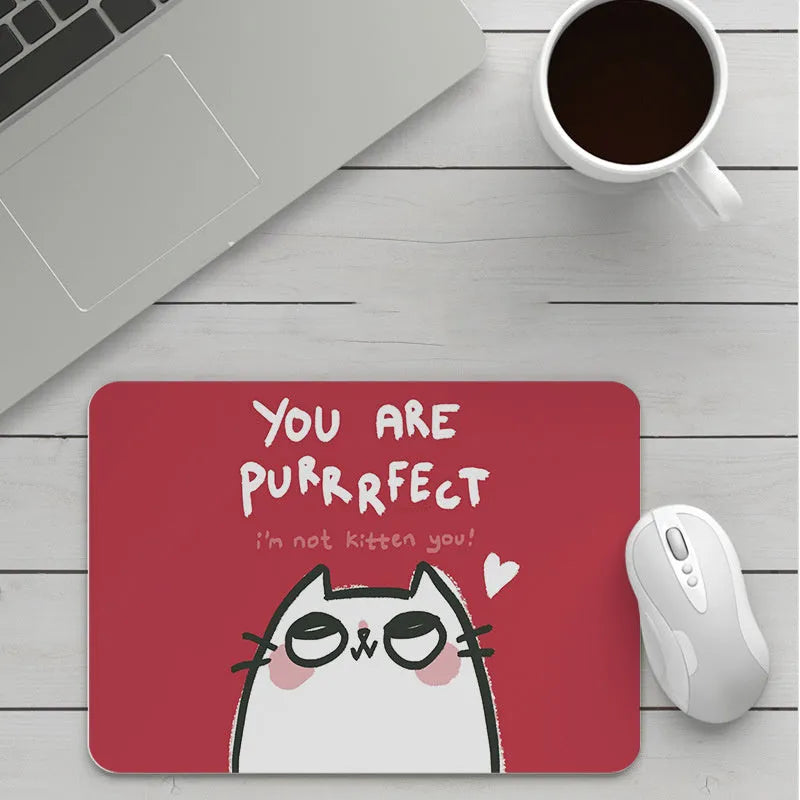 Custom cartoon thickening mouse pad on a desk, showing a colourful design with black stitched edge.
