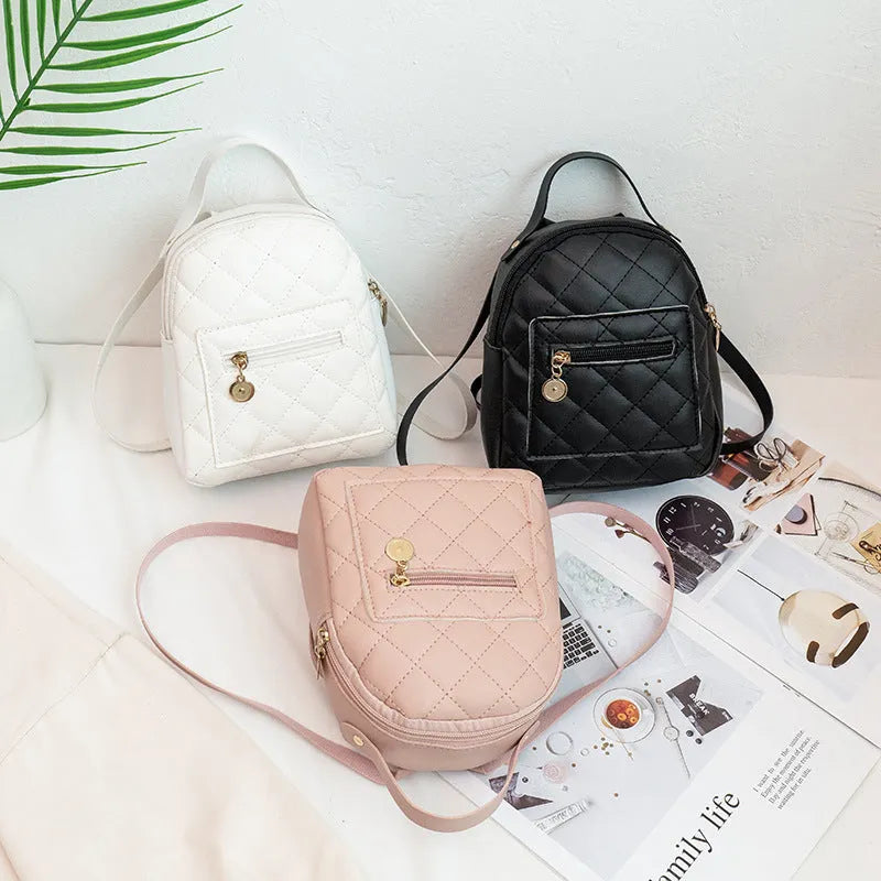 Girls' hard-shell vertical square backpack with embroidery in pink, showing front view and soft carry handle.