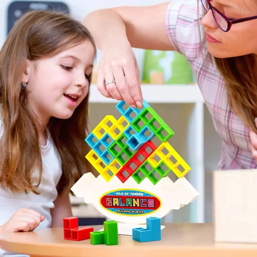 Plastic balance stacking game with 16 coloured building blocks, chassis, and base on a table