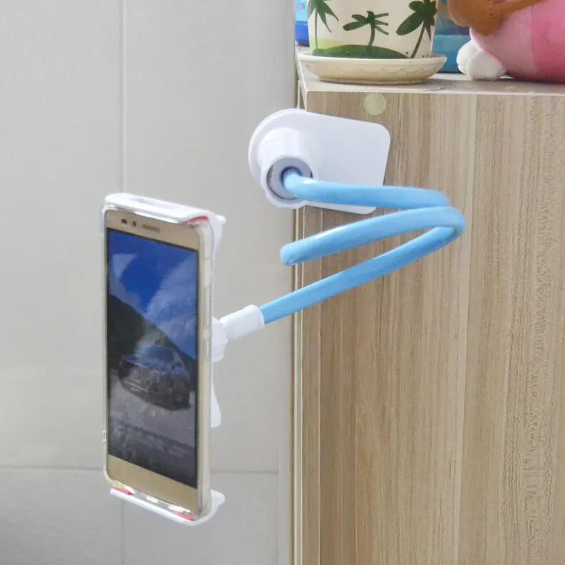 Black aluminium alloy phone holder with flexible arm on a wooden table holding a mobile phone.