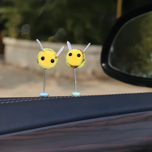 Spring-loaded bee car decoration with fur texture swinging from dashboard