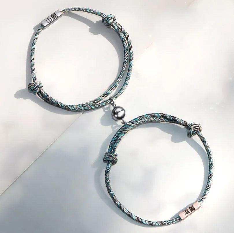 Pair of stainless steel magnetic couples bracelets with silver and rose gold finish, adjustable rope length