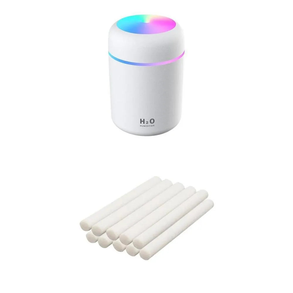 Pink USB mini humidifier with LED lights and water tank on desk