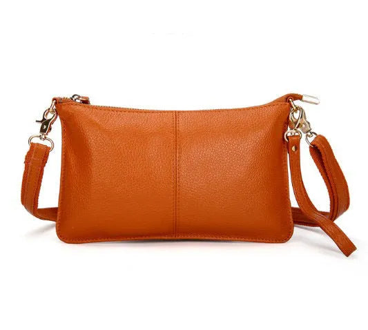 Lady cowhide slant bag in apricot showing top layer leather texture and dual straps