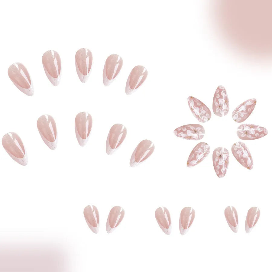 Short almond shaped removable false nails with glossy French tips and glitter flower decoration, colour C625.