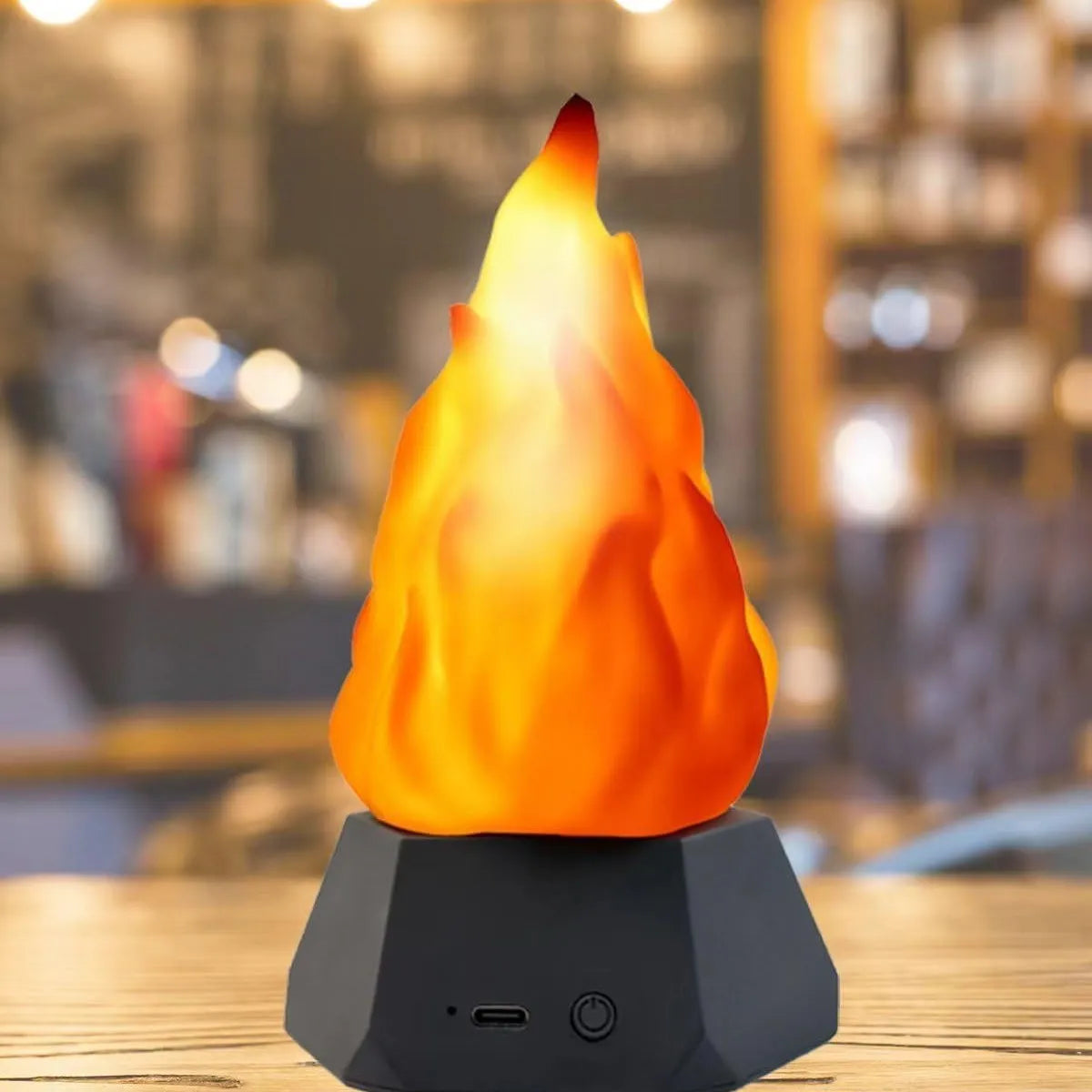 Flame-shaped outdoor decorative lights with black charging base on wooden surface