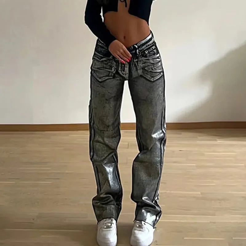 Washed blue high waist straight leg jeans on a model, showing contrast colour details.