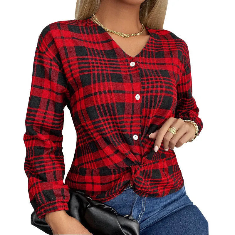 Woman wearing a loose-fitting purple, grey, and red plaid casual shirt with regular sleeves.