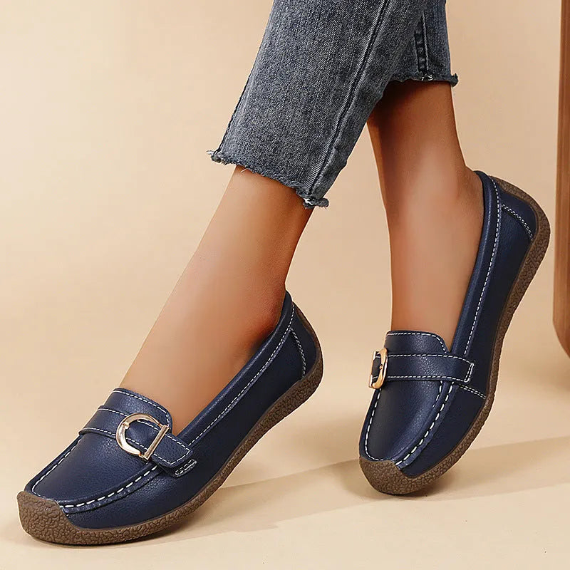 Women's beige loafers with round toe and flat heel on a light background