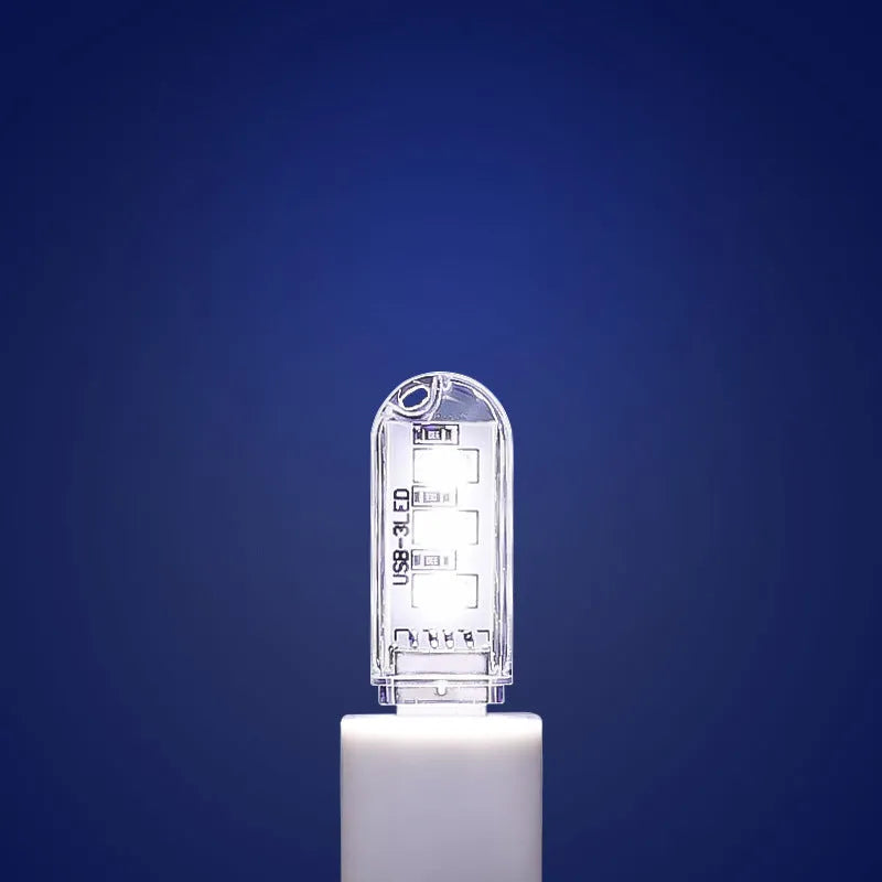 Small white USB-powered LED baby night light showing warm and cool light modes.