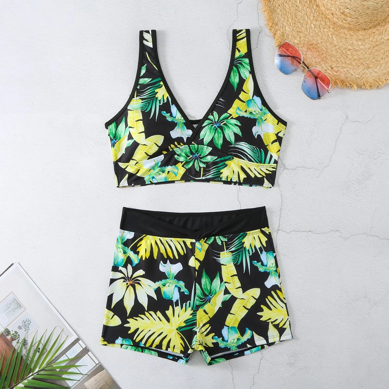 Women's two-piece swimsuit set with sleeveless top and printed boxer-style bottoms in a multi-colour pattern.