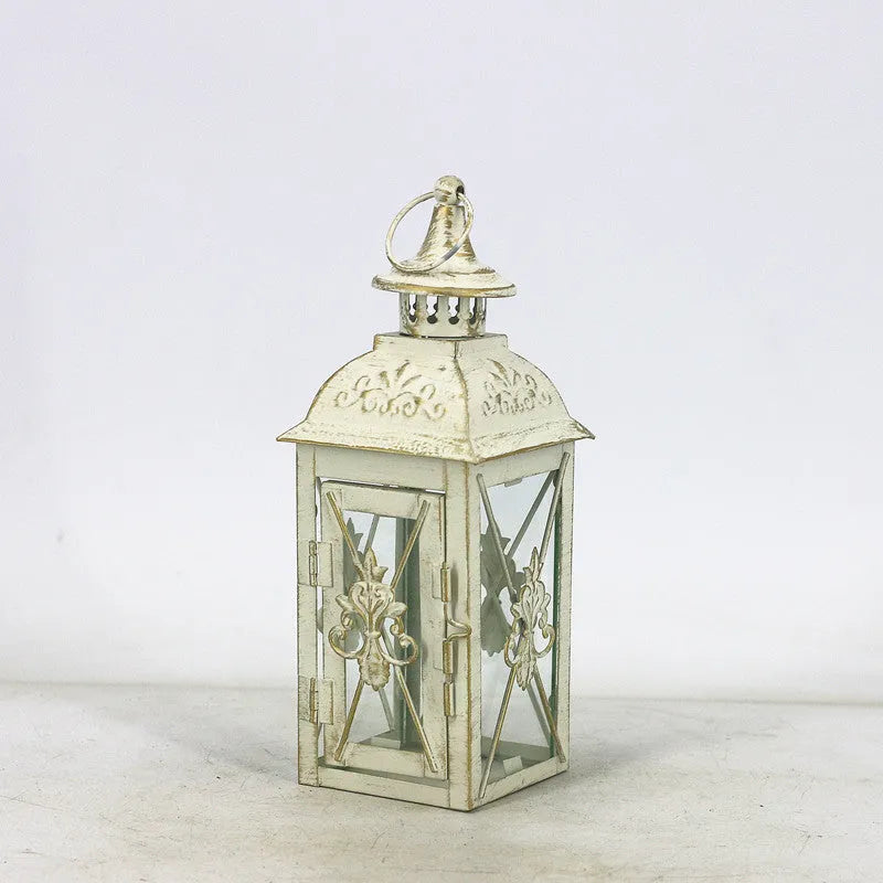Black wrought iron floor-standing storm lantern with tempered glass panels for outdoor candle lighting