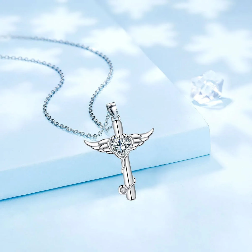 Close-up of a copper wings cross stethoscope pendant necklace on a chain.