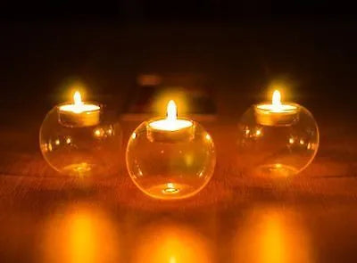 Handmade round transparent glass candle holder showing hollow centre for a candle