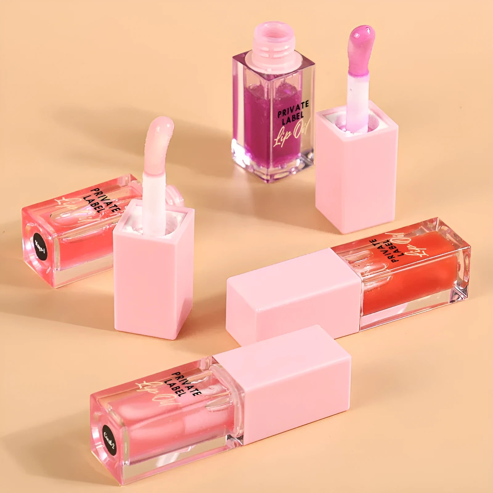 Set of six women's transparent lip gloss tubes in different colours and flavours