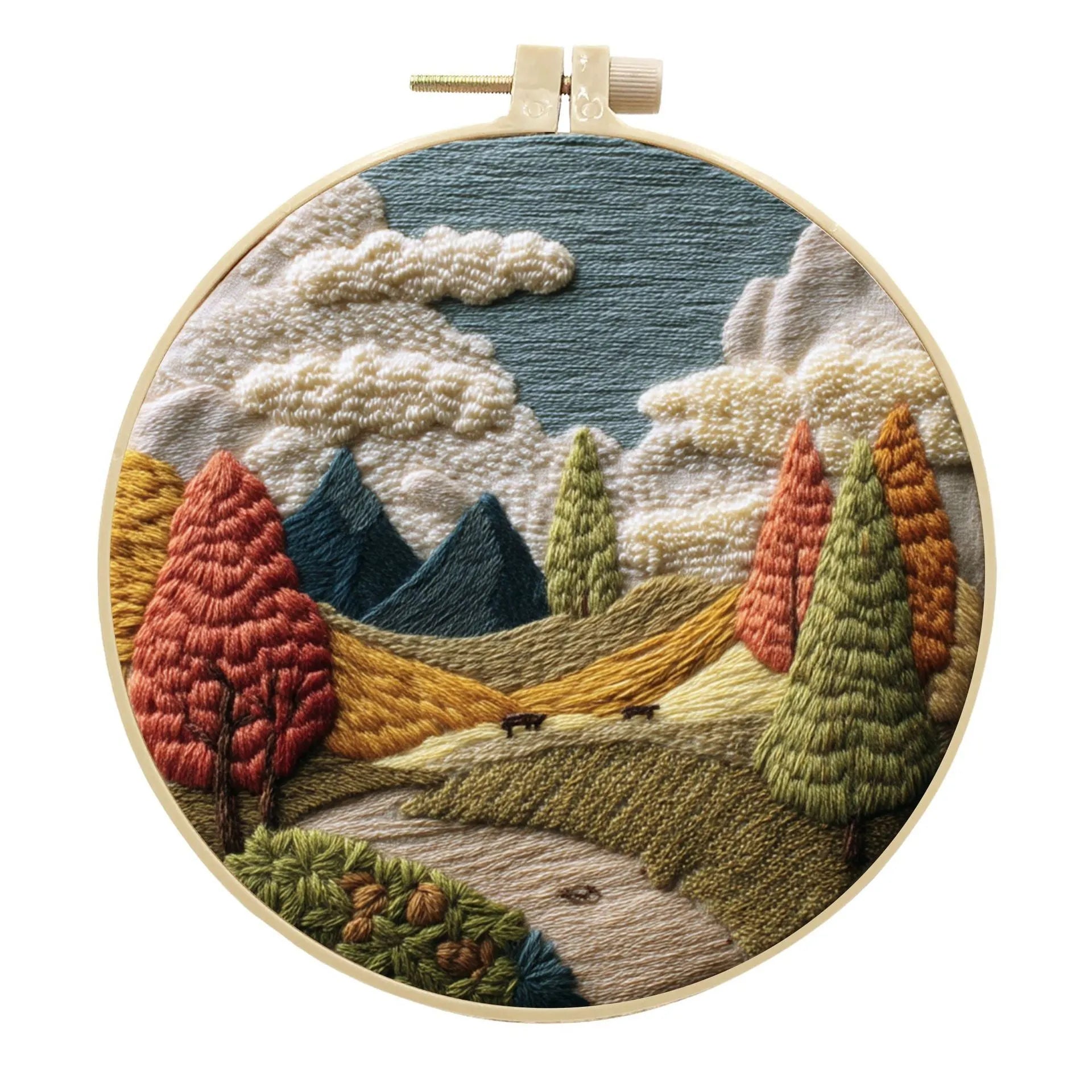 DIY landscape embroidery kit with cotton fabric, bamboo frame, threads and needles arranged for crafting