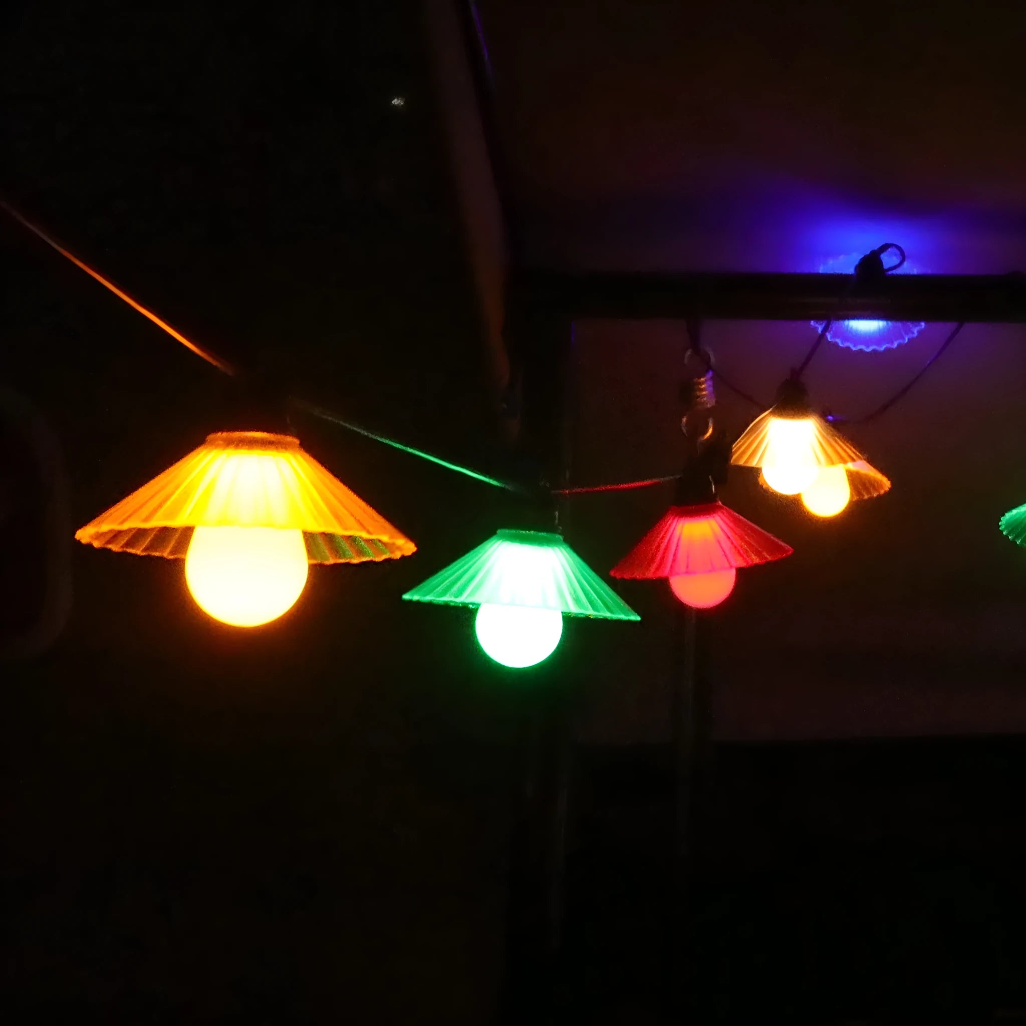Outdoor LED string lights with flower-shaped globes in various colours including warm white