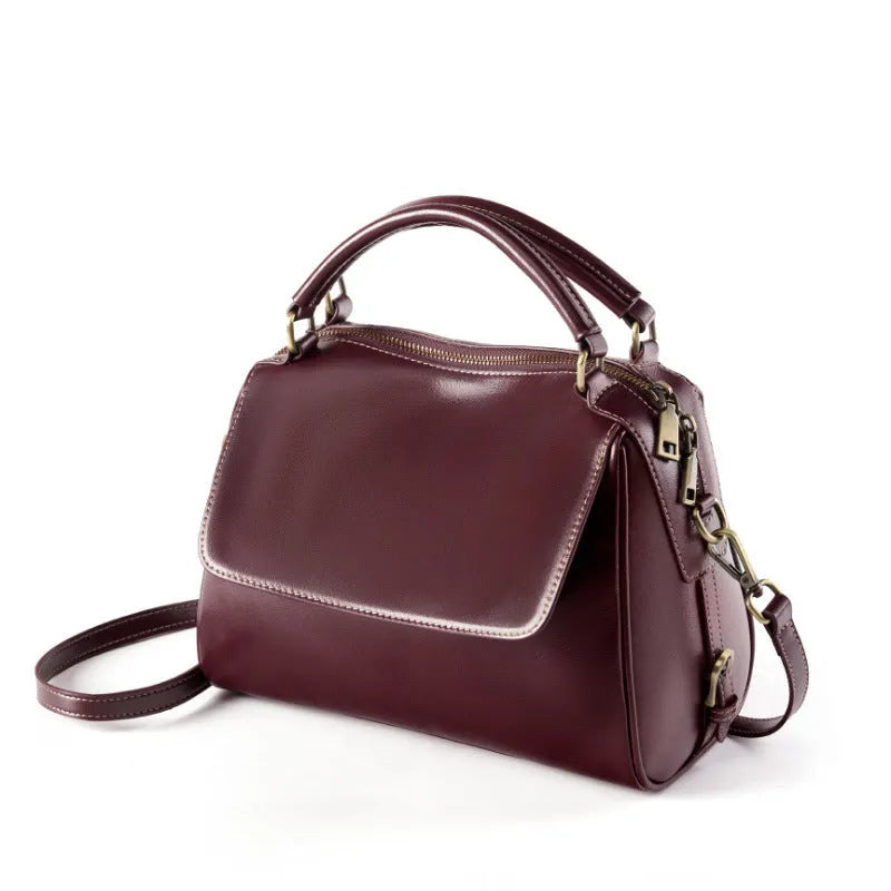 Women's soft genuine leather crossbody tote bag in a square shape with a double strap, shown in apricot colour.