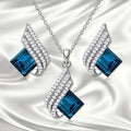 Women's necklace and earring set with glass pendant on cross chain, electroplated finish