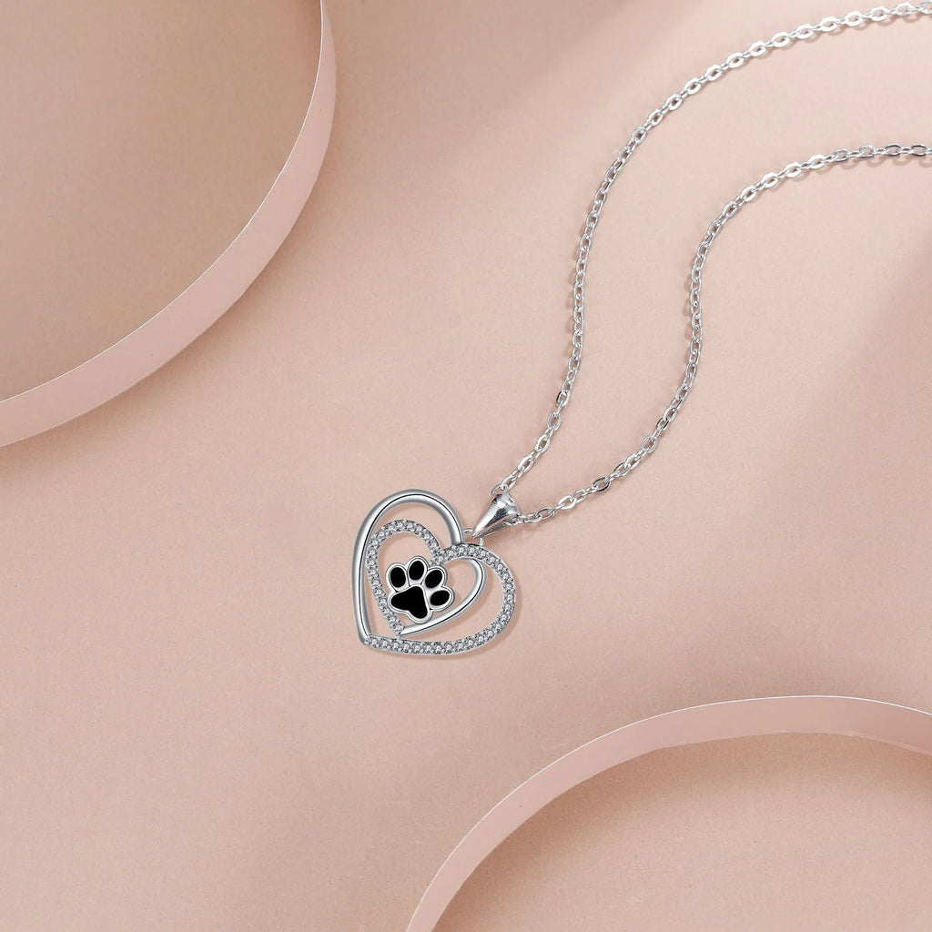 Women's copper necklace with dog paw print pendant and heart charm on cross chain