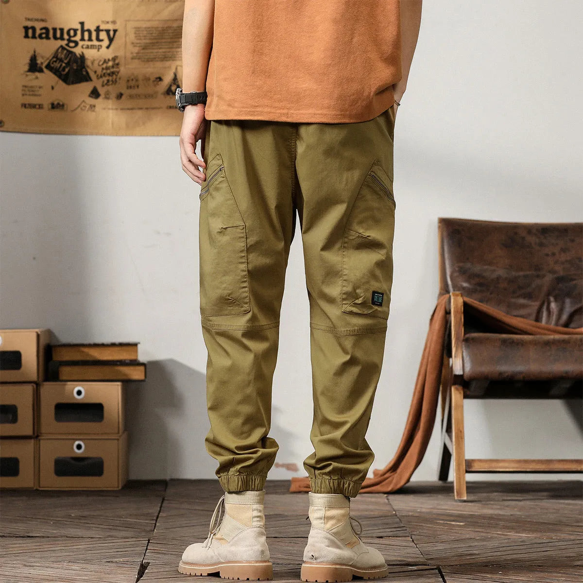 Men's khaki cotton tapered harem pants with an ankle band and loose fit.
